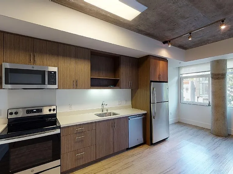 Stylish kitchen with stainless steel appliances and quartz countertops