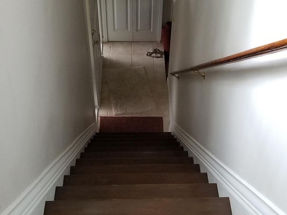 Entry foyer at bottom of stairs with coat closet on left --------landing at top leading into the living room
