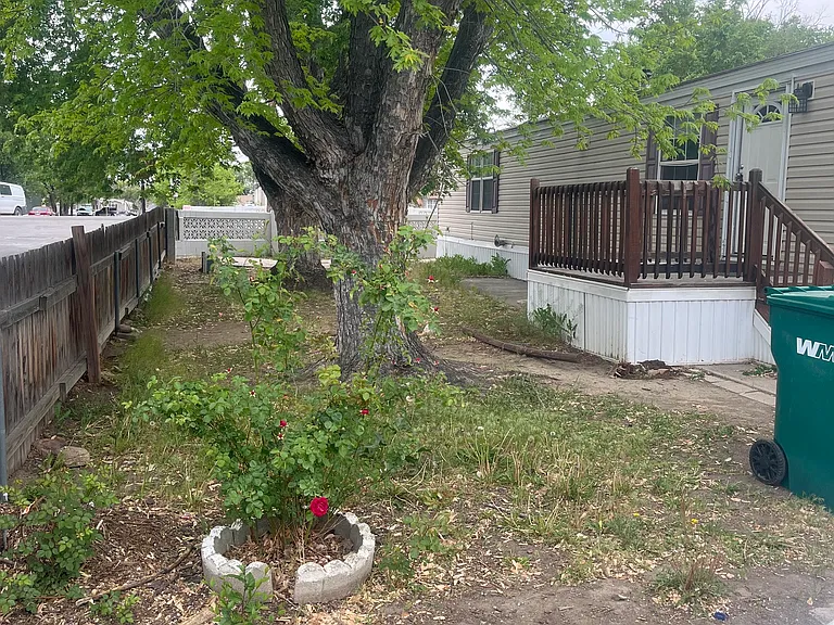 Partially fenced yard, large porch deck!