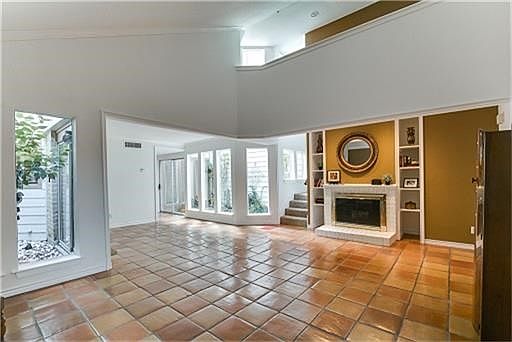 Living room, dining room view, Atriums for garden like setting, stairway leads to upper level guest bedroom and on suite bath.