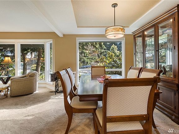Dining room with coffered ceiling sits close to kitchen.