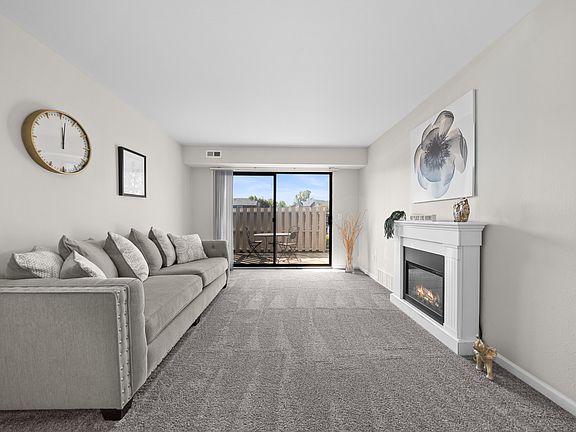 Living Room with Natural lighting at Three Oaks Apartments in Troy, MI