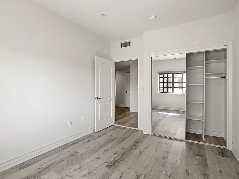 Bedroom with Closet with a Built-In Organization System