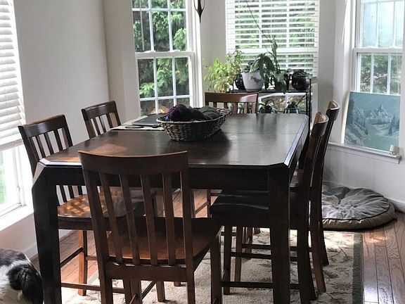 The dining room is also flooded with light from the bow window.