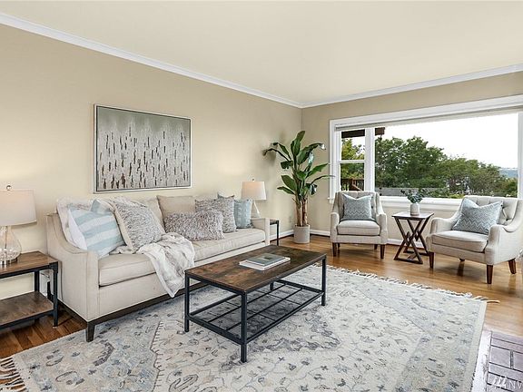 Hardwood floors throughout most of the main and upper levels complement beautiful living spaces and natural light flows through the west facing living room windows.