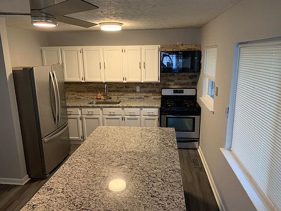 kitchen with granite top island and counter tops