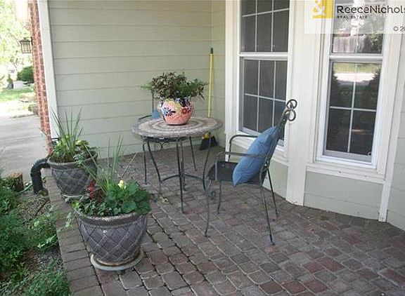 You have a perfect place to relax on the front paver porch.