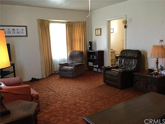 The kitchen is located off of the living room.