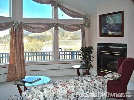 Upstairs living room has large windows : Great room for reading, relaxing, and enjoying the views an