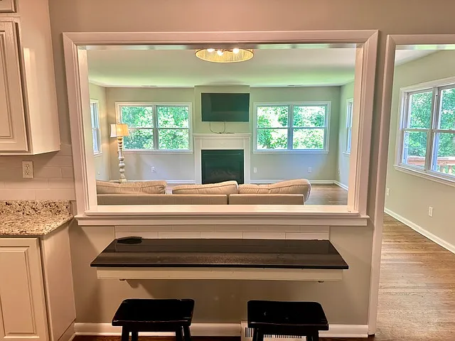 Passthrough from upstairs kitchen to large sunny living room.