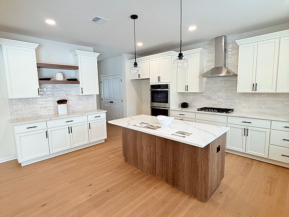 Styled gourmet Kitchen with luxury finishes and modern white cabinets. BR 40