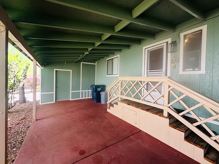 Carport, outdoor shed (straight ahead) and side door/mudroom entrance to home.