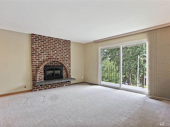 Living room features a gas-powered fireplace and quick access to the front deck.