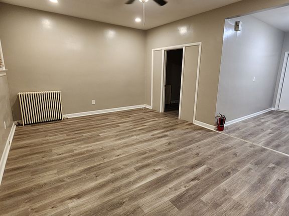 Living Room - New ceiling fan, new recessed lighting and distinctive flooring.