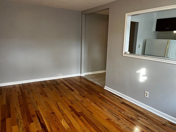 Living room, hardwood floors, freshly painted. Built in wall heating & air conditioning unit.