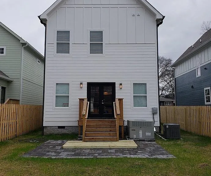 View of fenced-in back yard and rear patio area.
