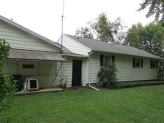 Back of the house.  Breezeway back door.  To the right is a screened in covered patio with inserts to keep out the snow in the w