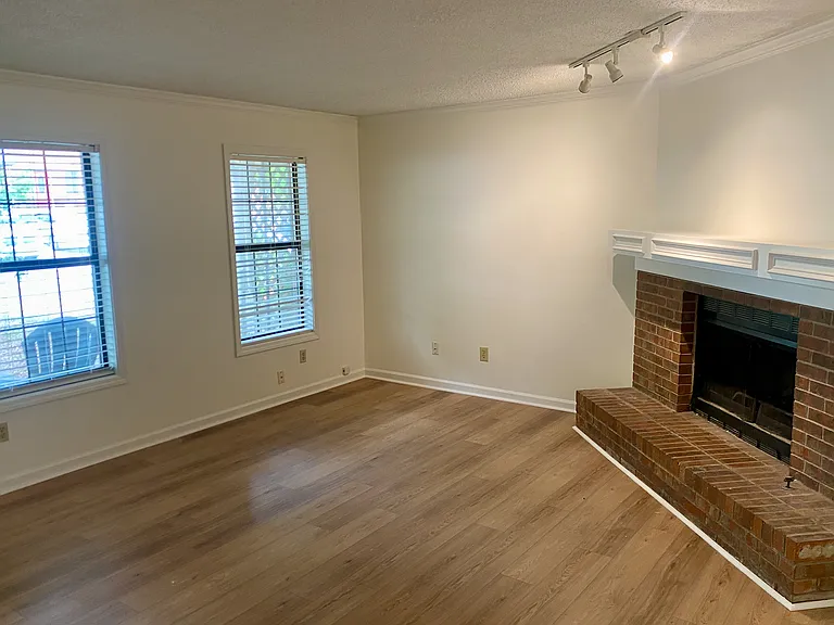 Welcome to your new sanctuary. A soothing wall color that's warm to match the wood floors. A fireplace with gas for those chilly nights. Spotlights add a dramatic effect.