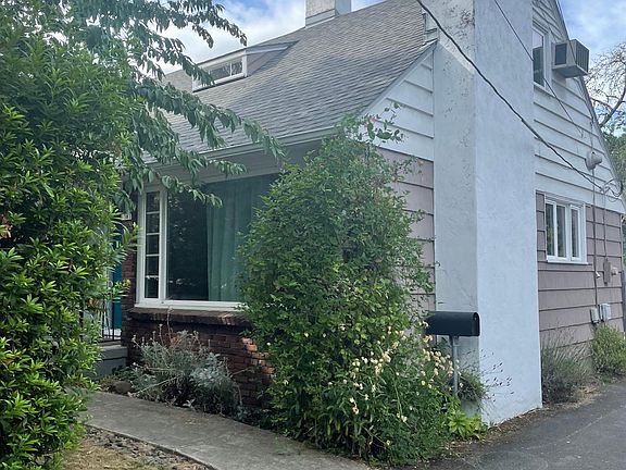Side of house, in the driveway.