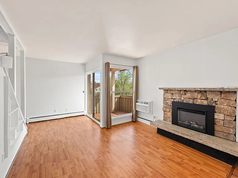 Main floor living area with newer electronic fireplace.