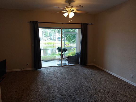 View of living room with sliding glass door access to porch.