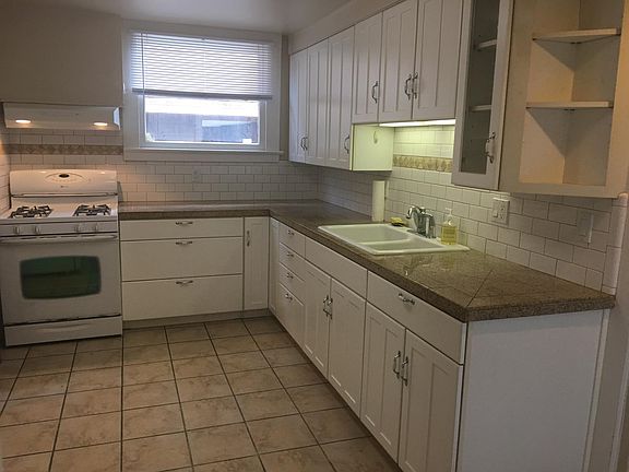 Remodeled kitchen with granite counters, tile floor and new