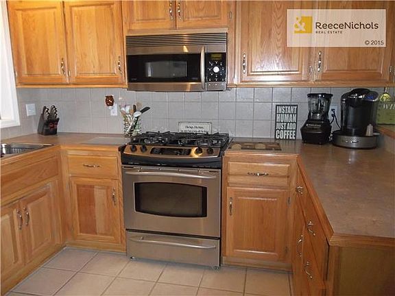 Kitchen with Stainless gas Range and Micro-wave.