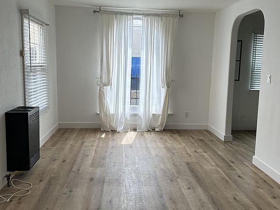 Open floor plan with dining area and living room space beautiful Spanish style windows and door openings