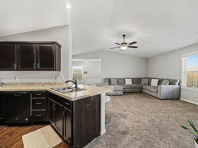 Bright, open-concept living with vaulted ceilings, abundant natural light, and seamless flow between the kitchen and great room_perfect for relaxing, entertaining, or working from home.