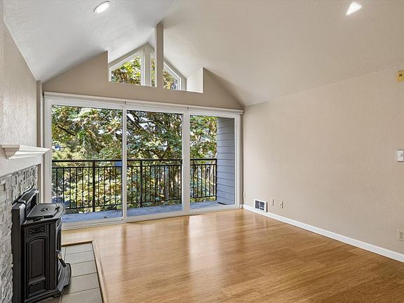 Living room w/ pellet stove and balcony