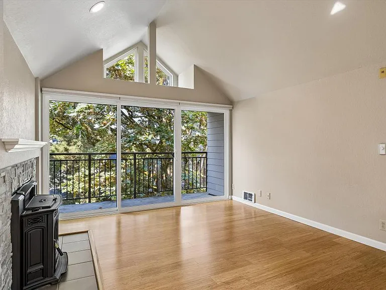 Living room w/ pellet stove and balcony