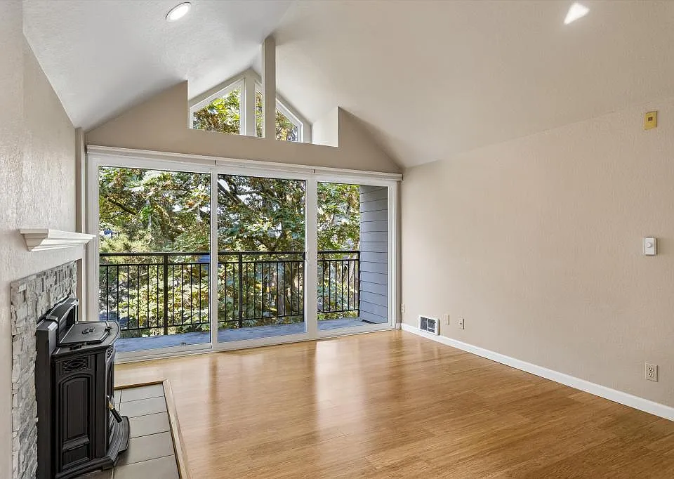 Living room w/ pellet stove and balcony