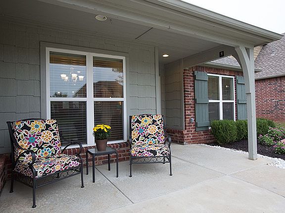Curb appeal is enhanced with professional landscaping and charming extended covered porch offering ample space for seating.