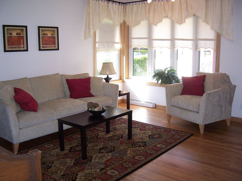 Living room features Bay window & hardwood flooring