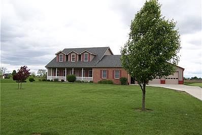 Beautiful rural setting with side load 3 car garage and pole barn