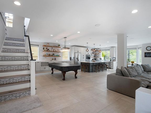 Large great room to eat, relax and play pool.