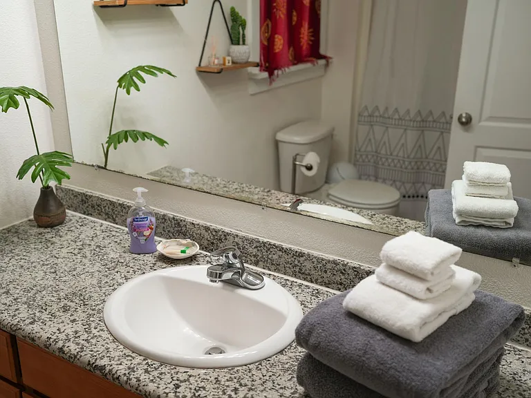 Full bathroom shared between bedrooms 1, and 2. This bathroom is large and has a tub.