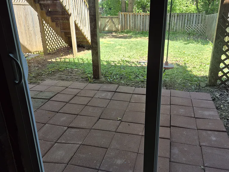 Paver patio outside sliding door at basement level