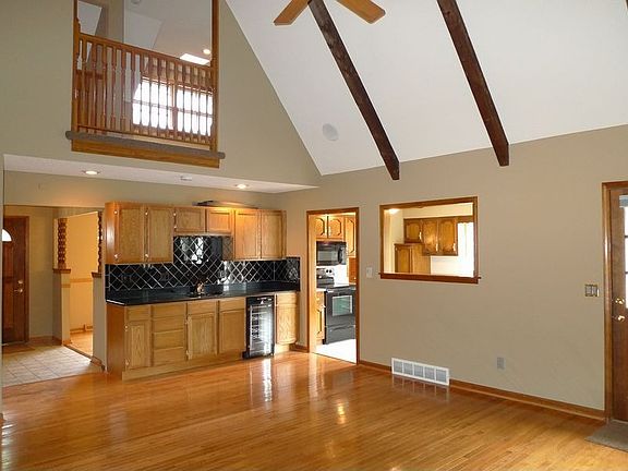 Tall vaulted ceilings & gleaming hardwoods in large Great Room!