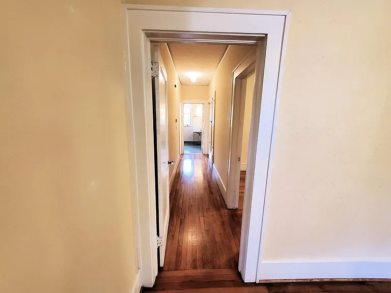 the Hallway with two bedroom entries and the HVAC controller