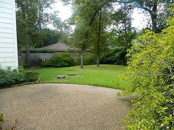 View of Patio and Back Yard From Driveway Gate