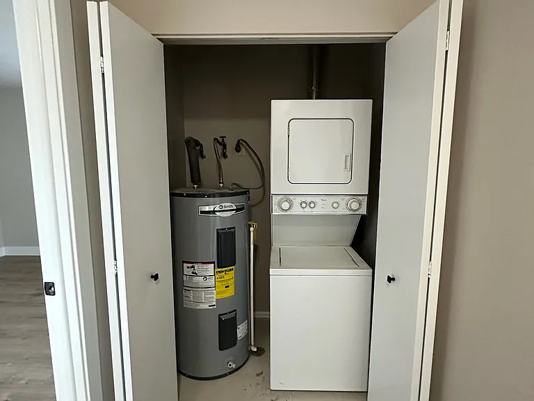 Laundry in the upstairs hallway. Primary bedroom entrance on the left.