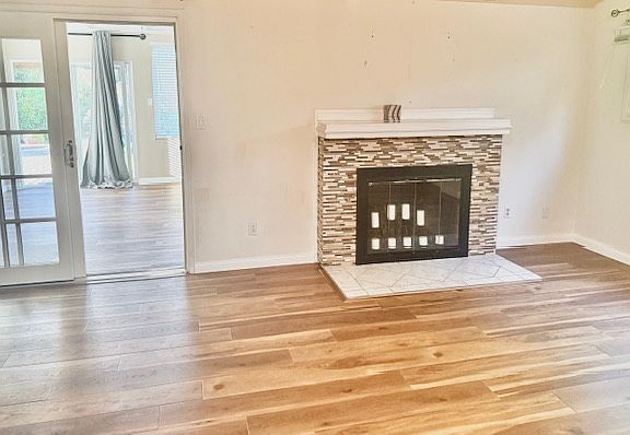 Cozy fireplace in the family room, perfectly positioned to face the dining area. The home is freshly painted throughout and offers a spacious living area_ideal for entertaining or family gatherings.