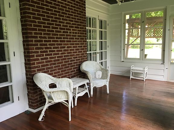 Sunporch with double French doors from living room and door to vine-covered deck