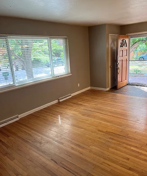Front living room with lots of windows towards the front yard.