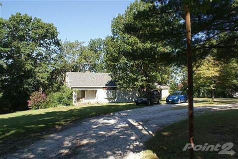 This home is located just east of the Ozark Park, close to the City Pool, The Property has a total of 3.89 ac m/l, It is split in 3 parcels now. It is zoned for R1-C.