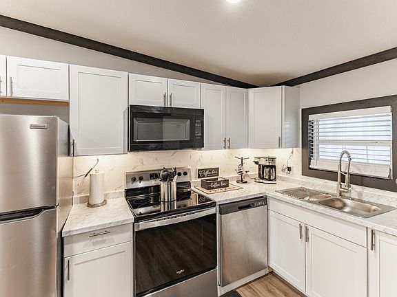 Full kitchen with brand new, stainless steel appliances.