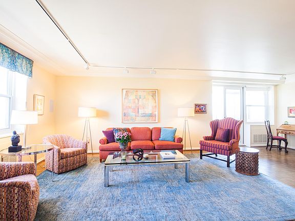 There is a large living room with ample seating and beautifu