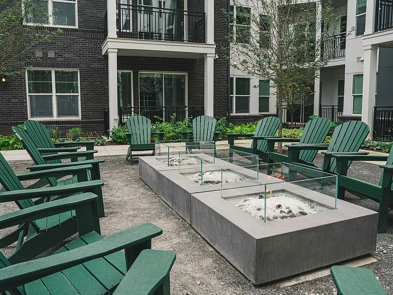 Modera Germantown's courtyard beckons with warm fire pits and inviting lounge chairs.