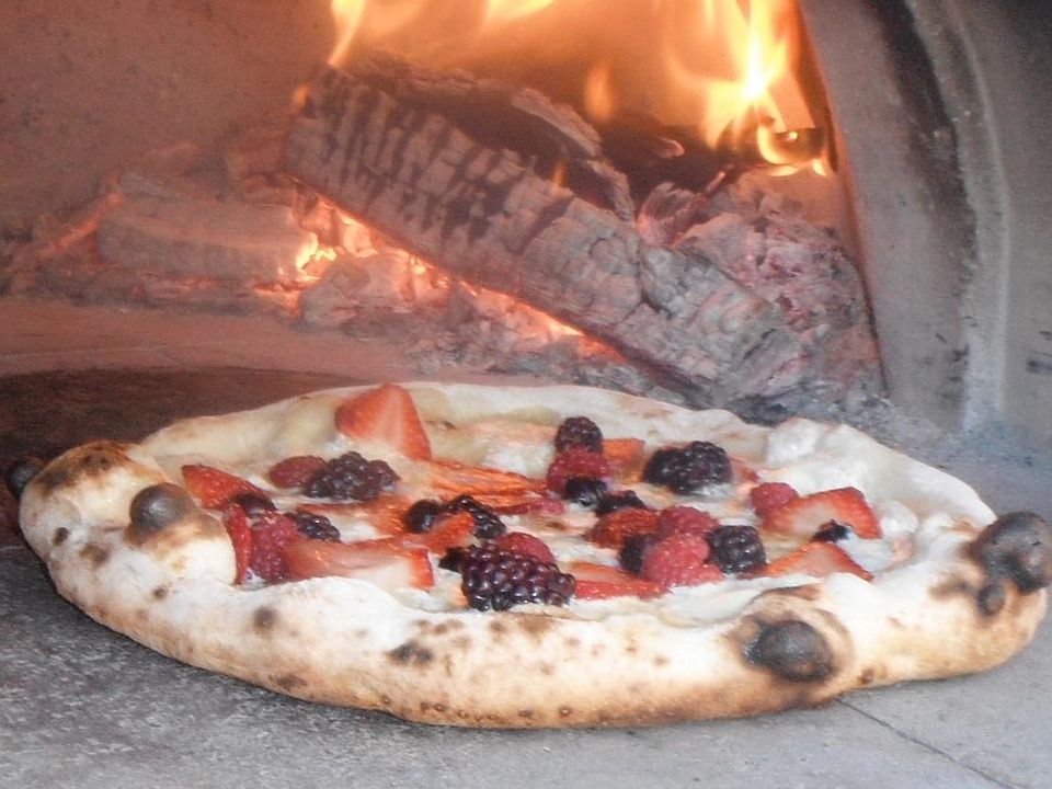 Enjoy pizza from the wood-fired oven